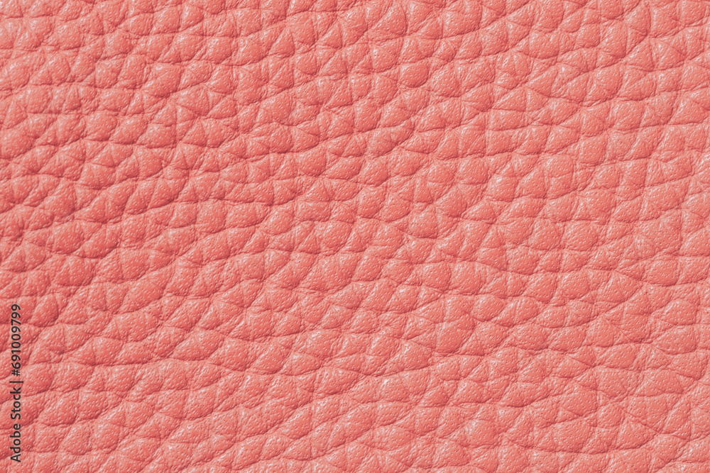Fototapeta premium Genuine grainy leather texture closeup, peach color, trendy background