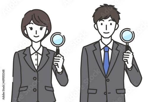 虫眼鏡を持つ女性会社員と男性会社員