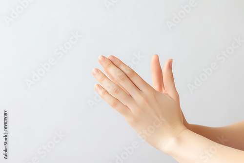 Young woman meditates on a light background. Hands close up. Biohacking concept, improving health and well-being through meditation