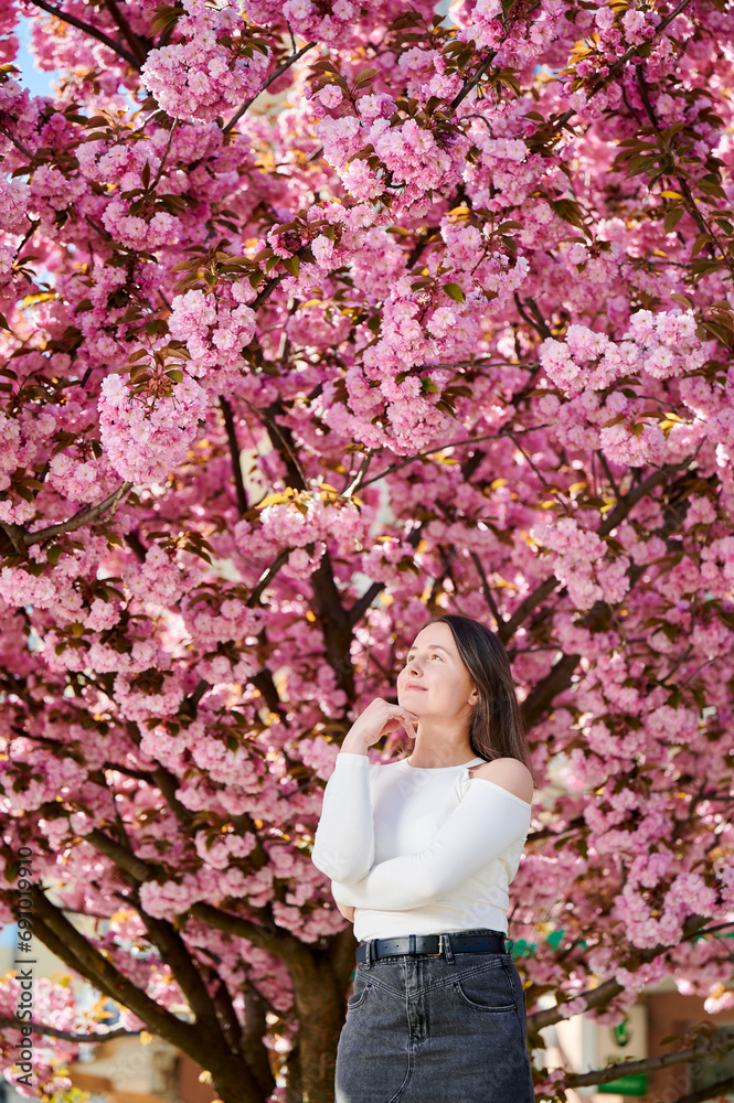 Woman allergic enjoying after treatment from seasonal allergy at spring. Portrait of happy beautiful woman smiling in front of blooming sakura tree at springtime. Spring allergy concept. Woman allergic enjoying after treatment from seasonal allergy at spring. Portrait of happy beautiful woman smiling in front of blooming sakura tree at springtime. Spring allergy concept.