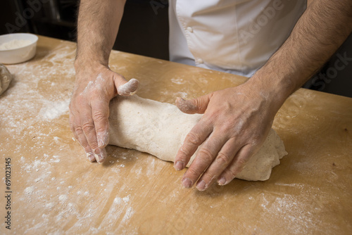 A baker prepares bread for baking