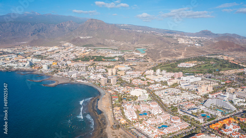 Aerial photo from drone to de Tenerife and beachs Adeje Playa de las Americas, Playa Honda,Playa de Troya, Playa de El Bobo.In the background Tenerife at sunset. Tenerife, Canary islands, Spain photo