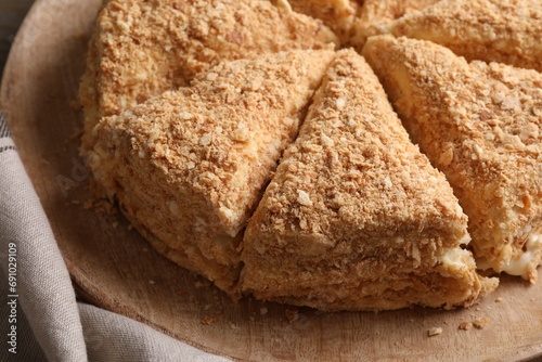 Delicious cut Napoleon cake on table, closeup