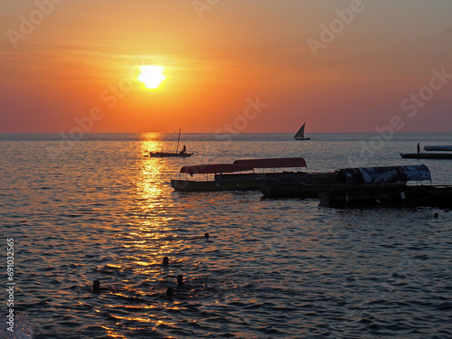 Boats on the calm sea, sunset © Natalia