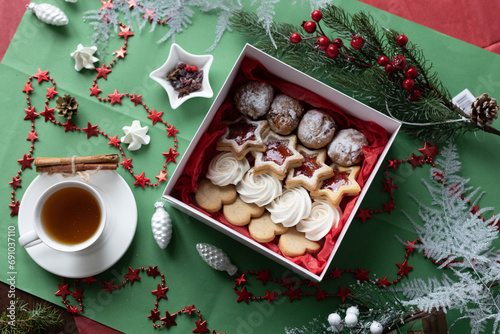 christmas star cookies and a cup of tea on a green background