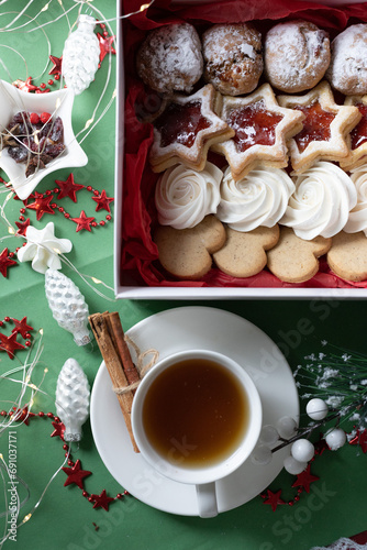 christmas star cookies and a cup of tea on a green background