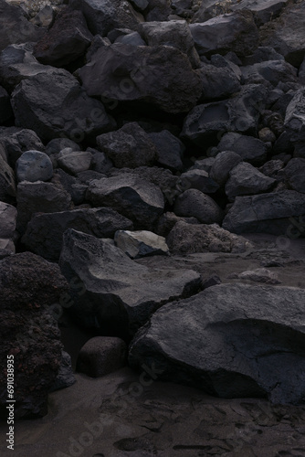 black rocks on the beach photo