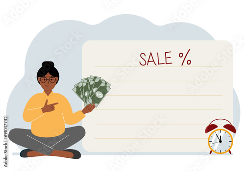 The women sits cross-legged and holds a lot of cash. Nearby is a poster with the text sale and a percent sign. Sale, discount or black friday concept.
