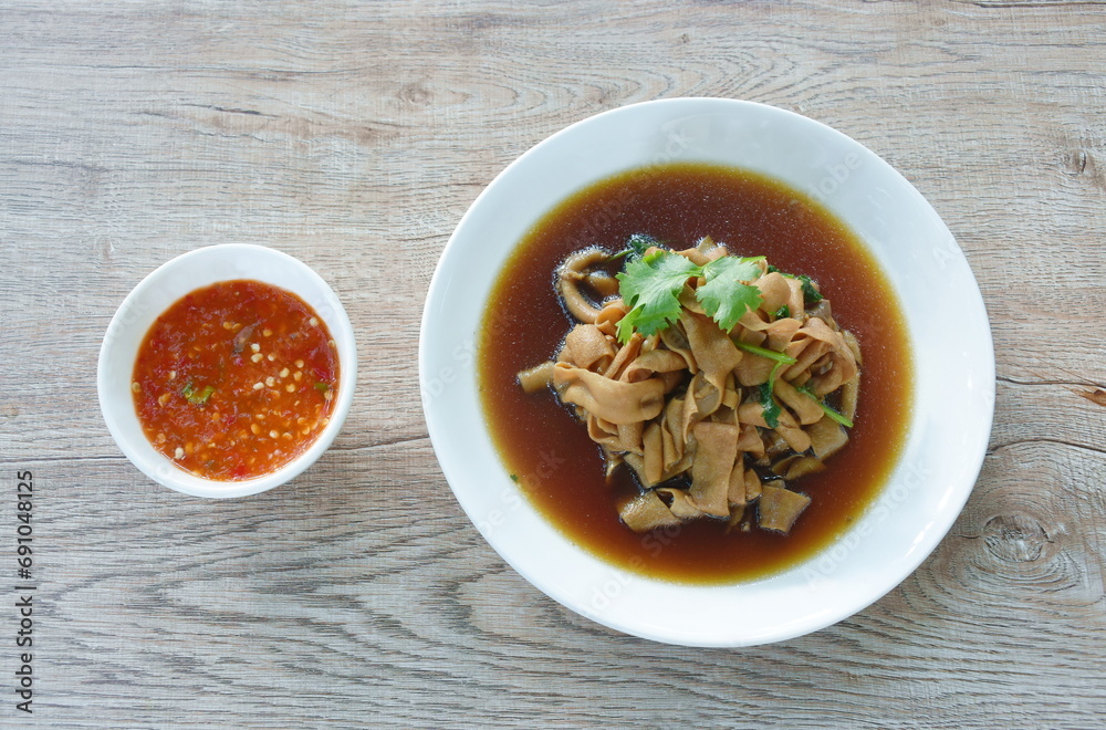 stewed duck intestine in brown soy soup on plate dipping spicy sauce stewed duck intestine in brown soy soup on plate dipping spicy sauce