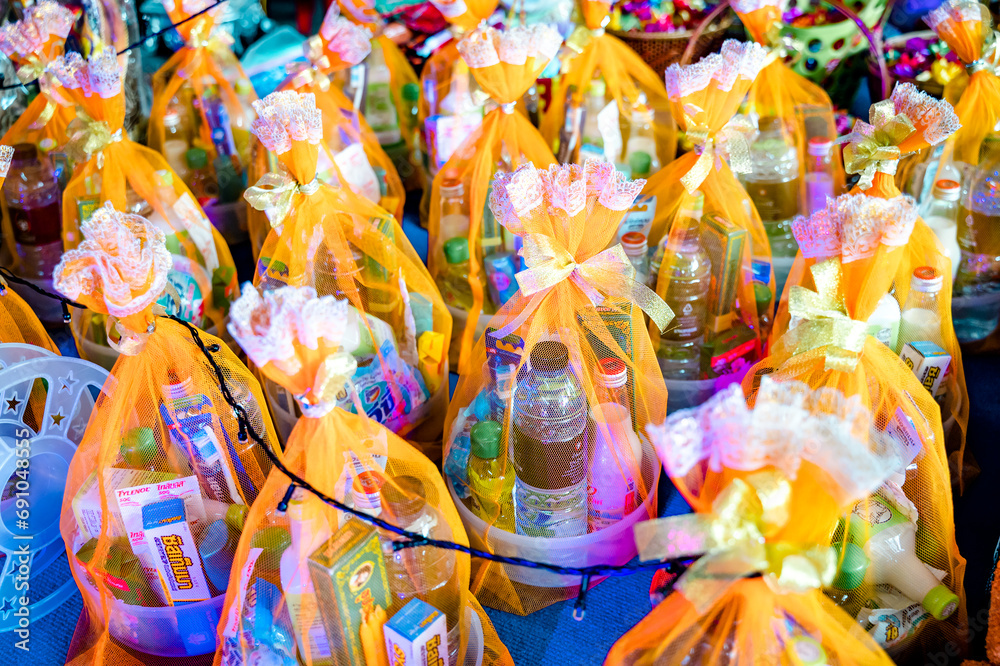 Obraz premium Close-up of the Give the offering dedicated to the monks set, an orange ribbon on top of the altar to make merit in Buddhism, a tradition of belief in Thailand, a set of offerings dedicated to the mon