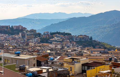 Panoramic view of Bronte town famous for Sicilian Pistachio over Simeto river valley on western slope of Mount Etna volcano in Catania region in Sicily, Italy