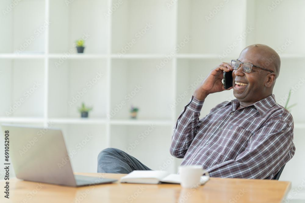 Happy of American professional businessman, wearing glasses working on laptop, remote studying using computer looking at screen watching seminar webinar at home office. Happy of American professional businessman, wearing glasses working on laptop, remote studying using computer looking at screen watching seminar webinar at home office.