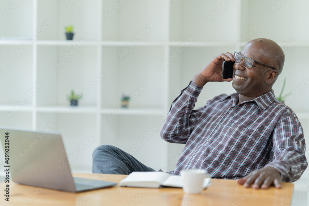 Happy of American professional businessman, wearing glasses working on laptop, remote studying using computer looking at screen watching seminar webinar at home office. Happy of American professional businessman, wearing glasses working on laptop, remote studying using computer looking at screen watching seminar webinar at home office.