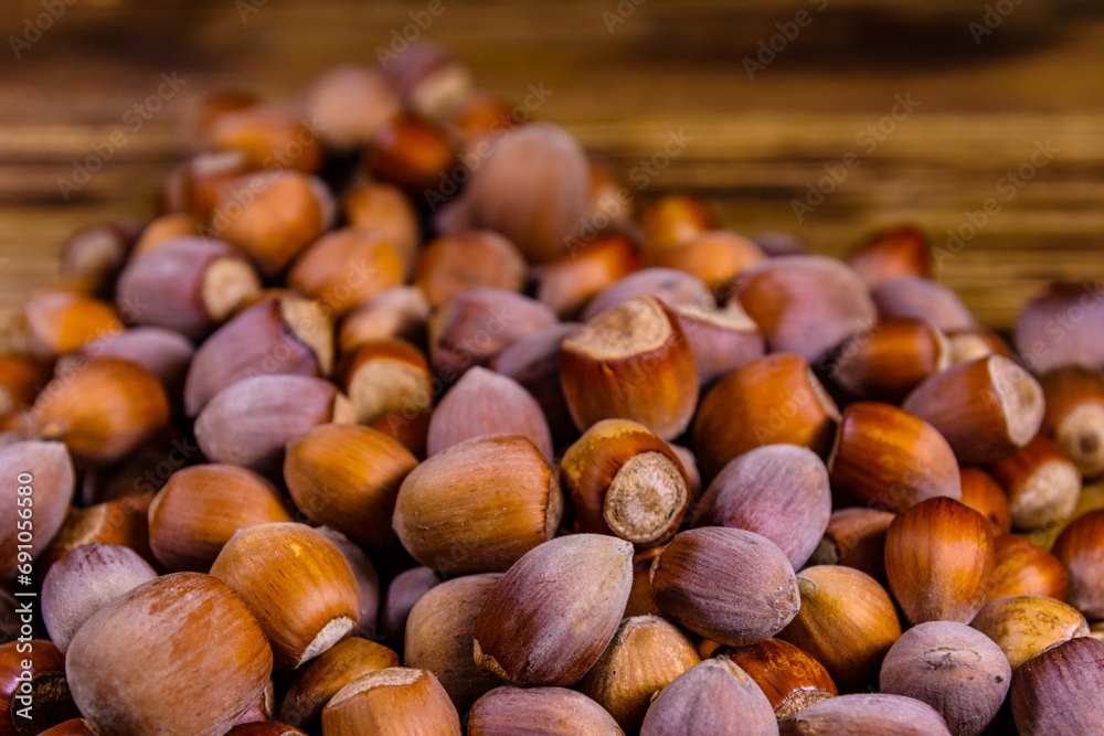 Pile of the hazelnuts on wooden table Pile of the hazelnuts on wooden table
