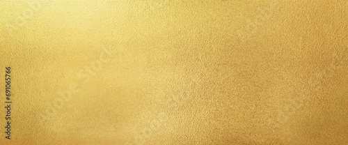Gold wall texture background. Yellow shiny gold paint on concrete wall surface, vibrant golden luxury wallpaper, horizontal © merrymuuu