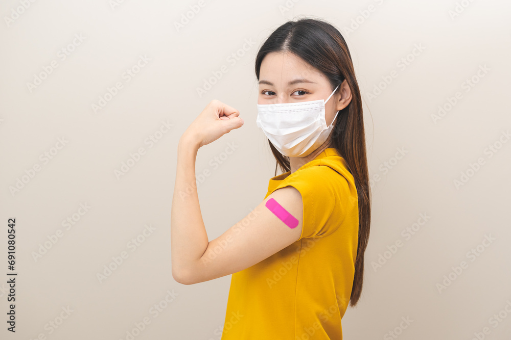 Healthcare of corona virus vaccination, happy asian young woman hand gesture showing strong with bandage, plaster on arm, getting vaccine immunity, giving injection influenza to protection pandemic. Healthcare of corona virus vaccination, happy asian young woman hand gesture showing strong with bandage, plaster on arm, getting vaccine immunity, giving injection influenza to protection pandemic.