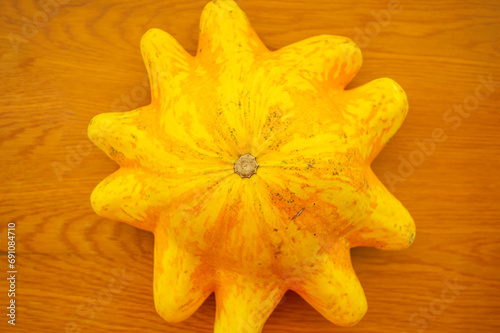 Yellow Turban turkish squash pumpkin that resembles a star or an octopus. Also known as Giraumon turban or Cucurbita maxima.  photo