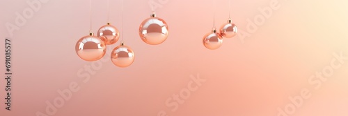 Christmas balls isolated on light pink background. New year decoration, festive atmosphere concept. Banner with copy space. Peach fuzz - color of the year 2024