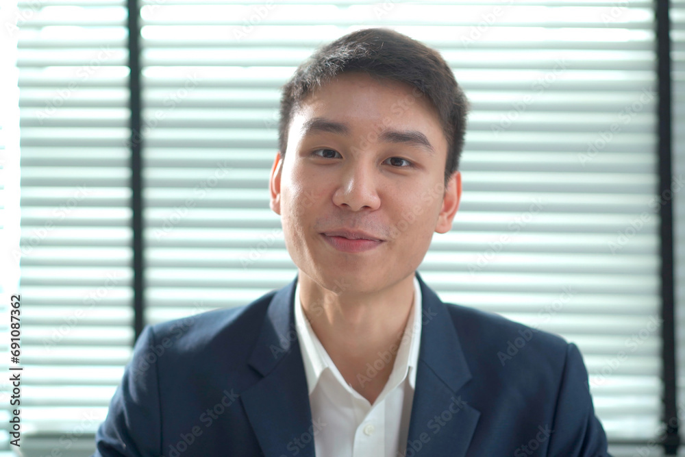 Smart - good looking senior asian businessman speaking to the camera in an office. Smart - good looking senior asian businessman speaking to the camera in an office.
