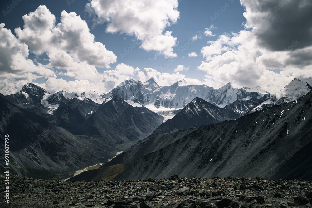 Mount Belukha in cloudy weather, view from a height of 3000 meters on the Karatyurek pass, Altai Mountains
