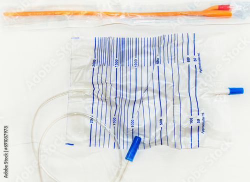 Urinary catheter and 2 liter sterile drainage bag is isolated on a white background.