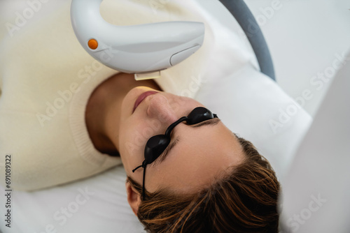Phototherapy  photorejuvenation  IPL in a beauty salon. Care for a woman s face.