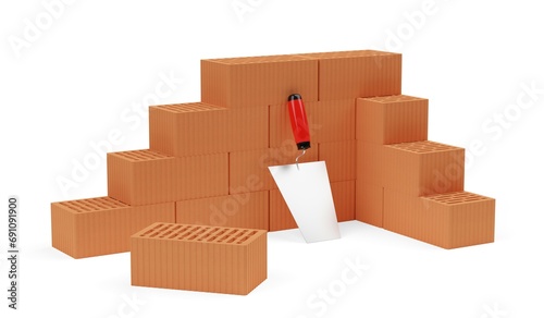 Cornered stack of red brick stones with single brick in front and trowel on white background, construction, building trade or masonry industry concept photo