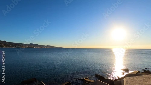 Sunset over Malageta beach on sunny day in the morning in Malaga, Spain photo