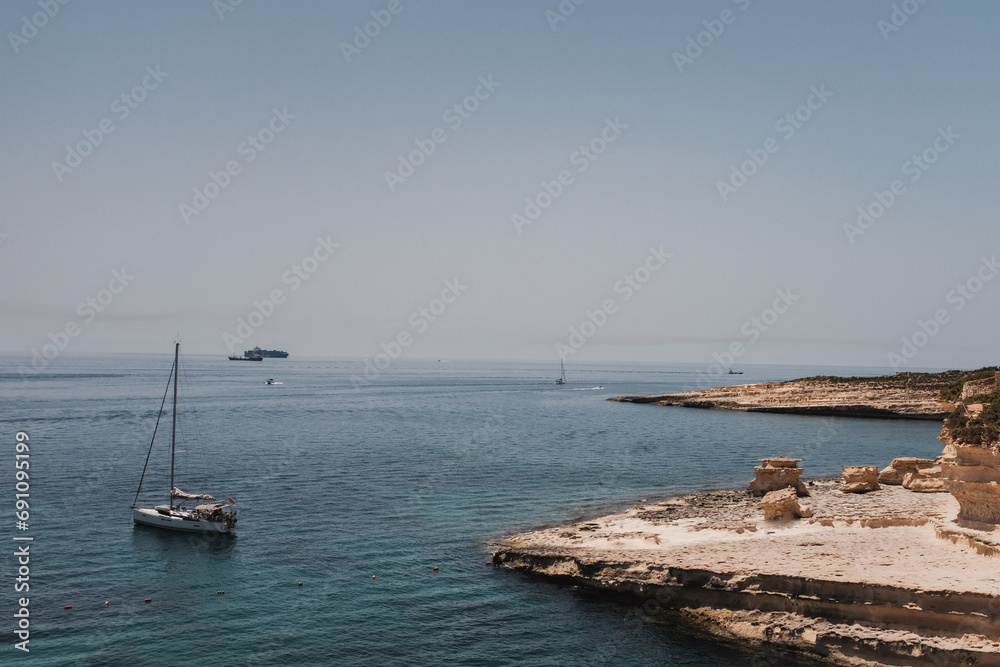 Horizon at the stony sea coast with boat
