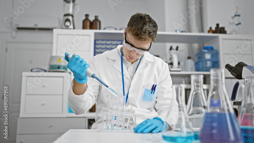 Handsome young caucasian scientist man, meticulously pouring liquid into test tubes in a high-tech lab, elevating the boundaries of medical research