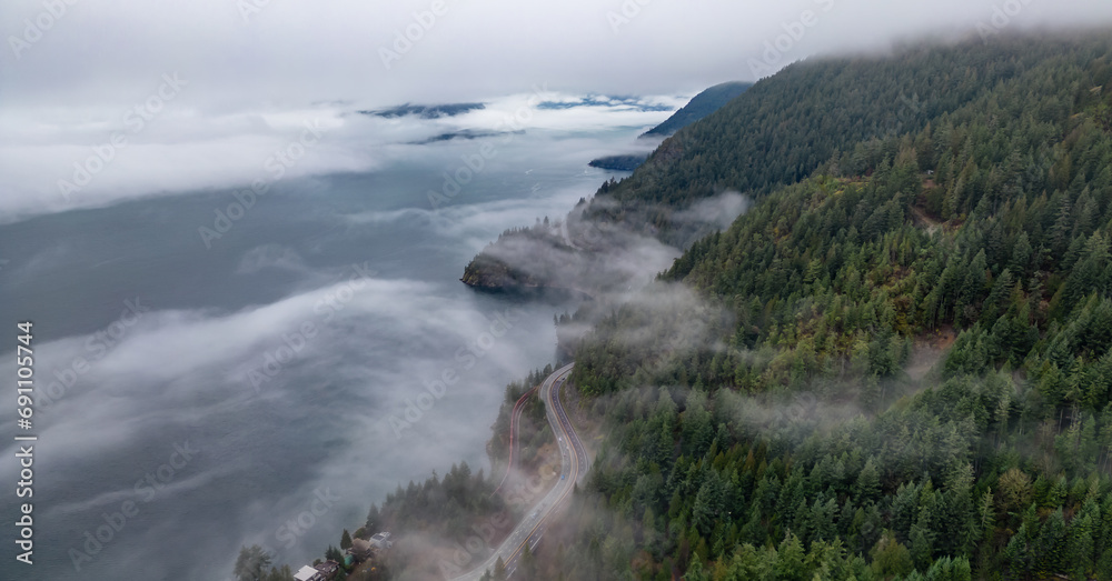 Howe Sound covered in Clouds and Fog during morning. Aerial Panorama Howe Sound covered in Clouds and Fog during morning. Aerial Panorama