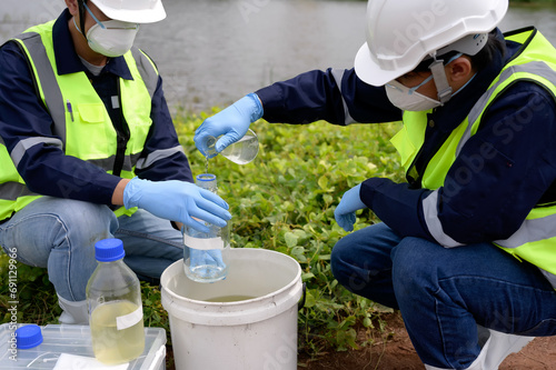 Environmental Engineers Team Take Water Samples at Natural Water Sources. Water that smells bad Near Farmland, Fish Ponds May Be Contaminated by Toxic Suspicious Pollution Sites.