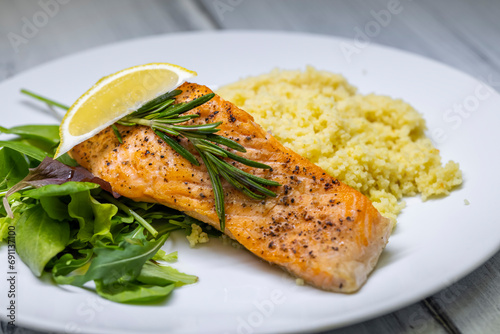 grilled salmon served with couscous and vegetables salad