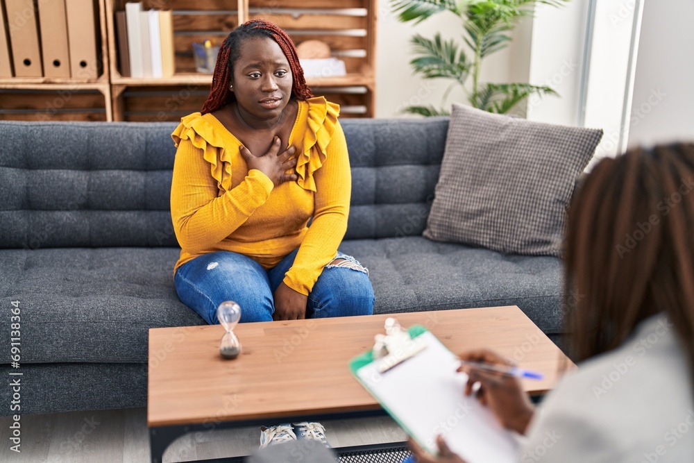 African american women psychologist and patient having mental therapy sitting on sofa at psychology clinic African american women psychologist and patient having mental therapy sitting on sofa at psychology clinic