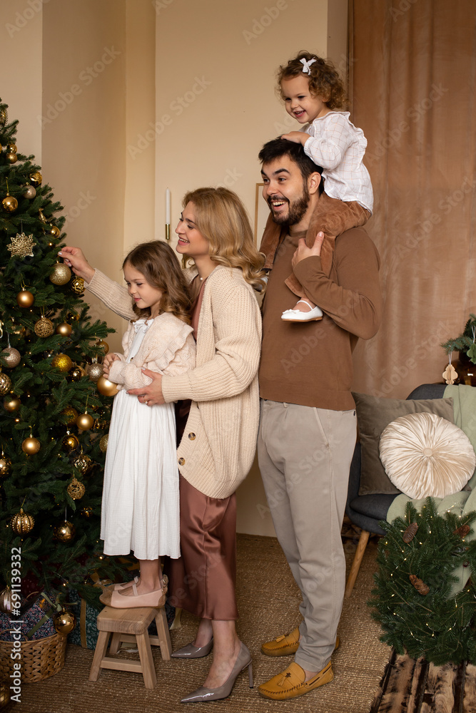 happy family enjoying their time together decorating Christmas tree happy family enjoying their time together decorating Christmas tree