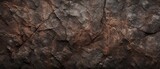 Dark brown rock texture background. dark red brown rough mountain surface with cracks. textured stone background with space for design