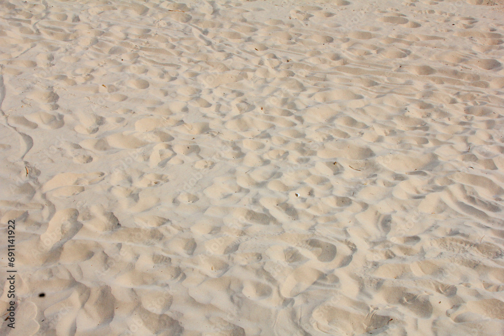 Close image of sand with several footprints marked Close image of sand with several footprints marked