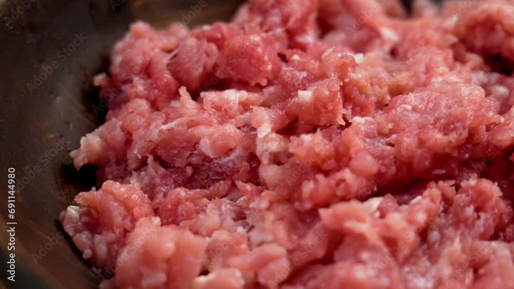 Raw ground pork in wooden bowl closeup. Fresh meat forcemeat. Rotation Raw ground pork in wooden bowl closeup. Fresh meat forcemeat. Rotation