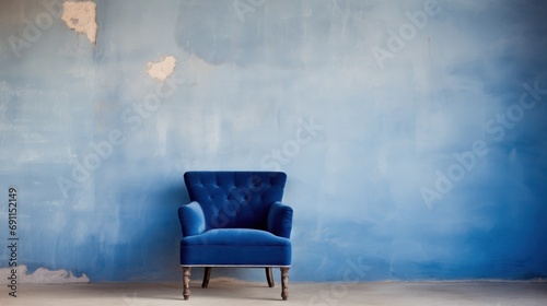  a blue chair against a blue wall in a room with peeling paint on the walls and peeling paint on the walls and a peeling paint chipping off the wall. photo