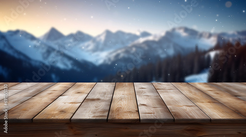 Empty wooden table with scenic moutains and snow in blurry background