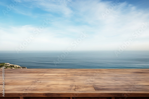 Empty wooden table with scenic sea and blue sky in blurry background