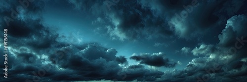 Black blue night sky with clouds. Dark teal skies background with copy space for design. Wide banner. Gloomy dramatic sky scene
