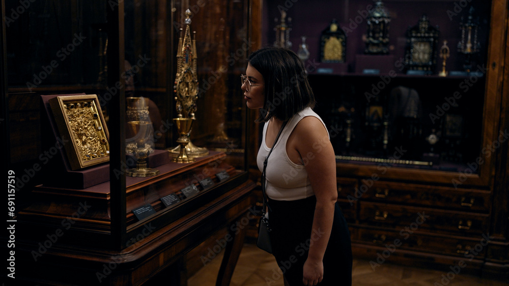 Young beautiful hispanic woman looking at art exhibition at imperial treasure museum in Vienna Young beautiful hispanic woman looking at art exhibition at imperial treasure museum in Vienna