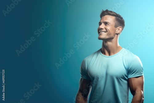 A man wearing a blue t-shirt smiles at the camera. Perfect for a friendly and approachable image