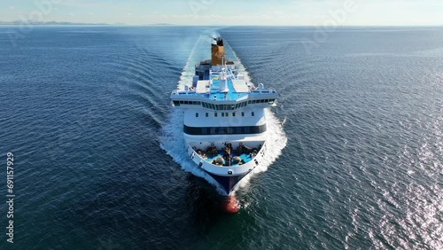 Aerial drone tracking video of passenger ferry bow cruising in high speed the Aegean deep blue sea photo