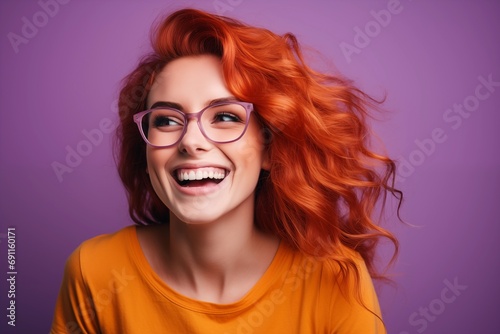 a smiling woman wearing glasses and smiling at the camera, wearing an orange t -