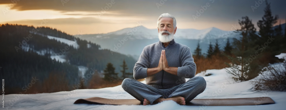 An elder man in a peaceful meditative pose is seated in the snow, exuding serenity against a mountainous backdrop. The harmonious blend of tranquility and nature's majesty, inner peace at sunrise. - obrazy, fototapety, plakaty 