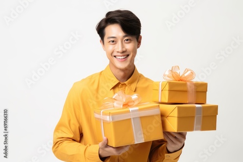 Cheerful young Asian man holding many present boxes with on white background. Black friday sale and Boxing day. Gift for woman and Valentine day. Christmas and Chinese New Year concept