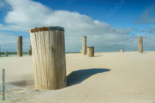 Village of wooden poles at the beach near Petten, the Netherlands photo