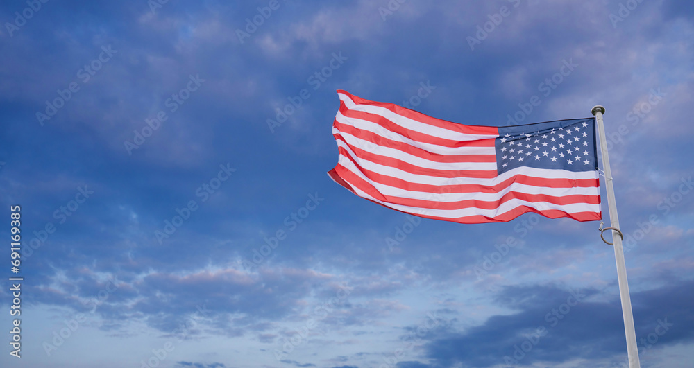 American flag waving in wind. Symbol of the United States of America. American flag waving in wind. Symbol of the United States of America.